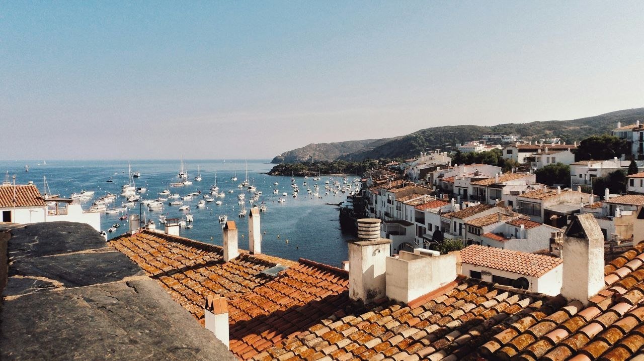 Coastal village in Spain with tiled roofs and a fishing harbor